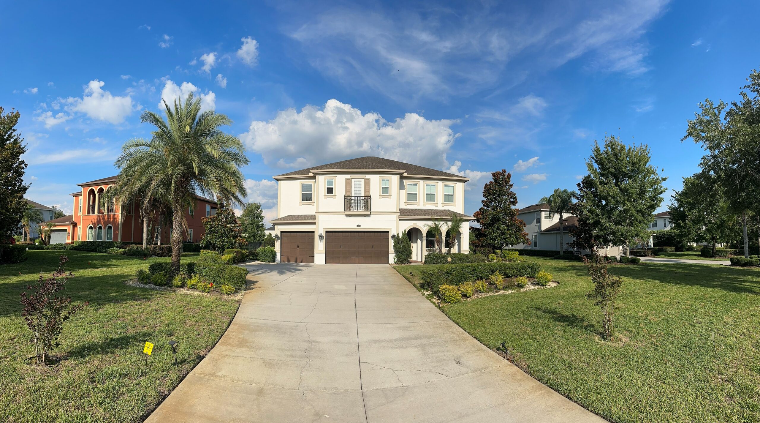 Outdated brick courtyard patio with dying ficus hedge and limited shade in Boca Raton Florida