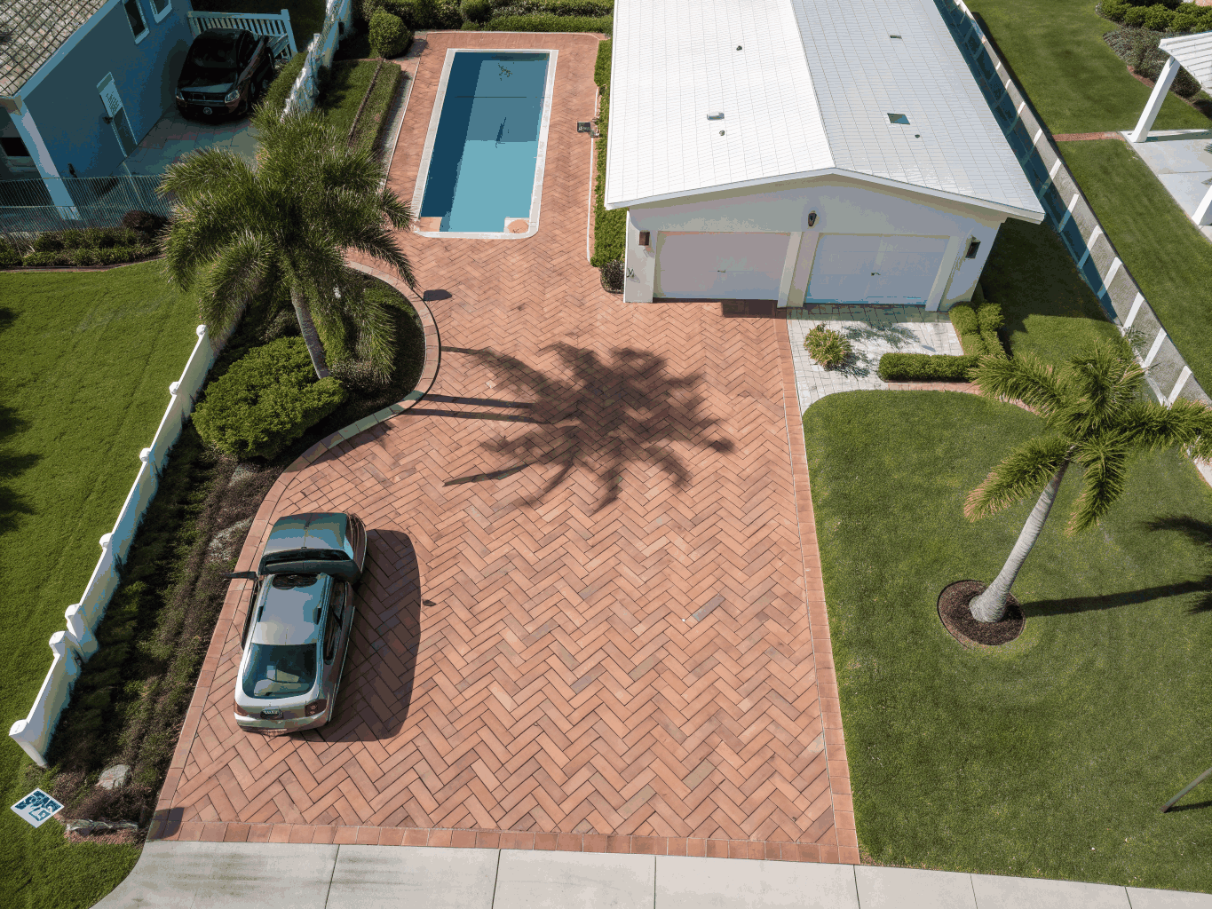 Sparse grass yard with basic concrete pool deck before landscape redesign